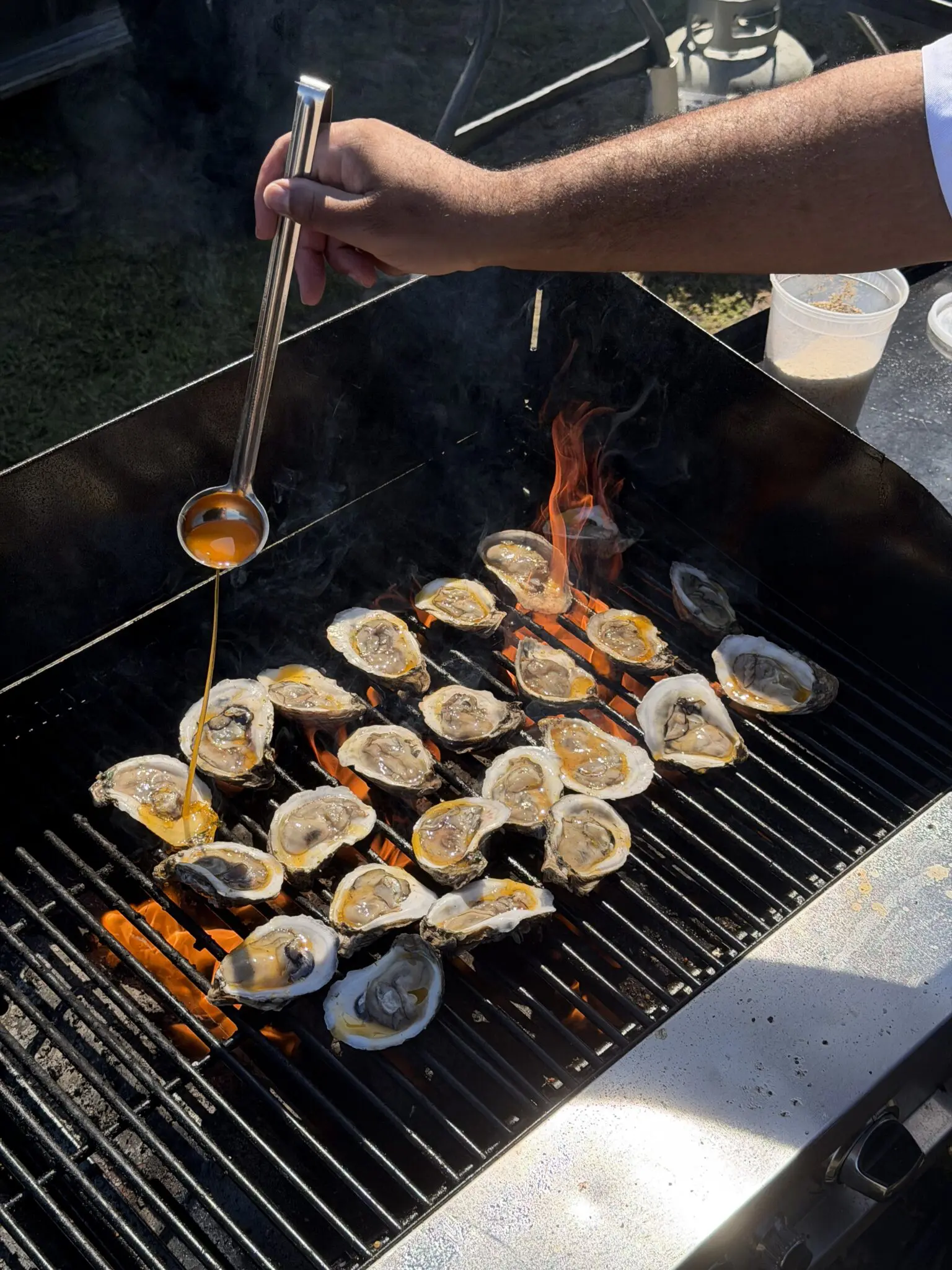 Oysters grilled over an open flame by Messina’s Catering at Fair Grounds Race Course in New Orleans